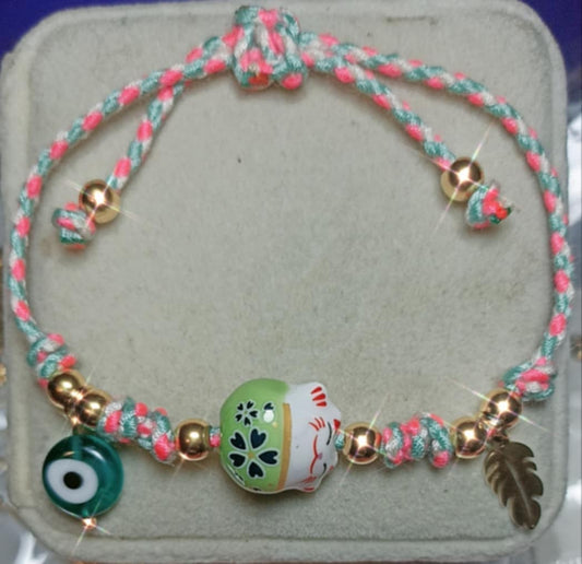 Pulsera de cordón trenzado de algodón con dije de gatode la suerte color verde.
